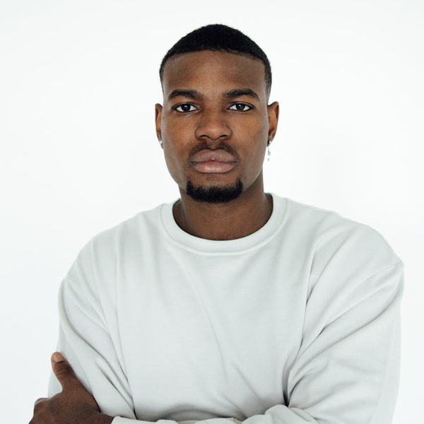 Person starting a simple yoga pose, looking calm and focused.